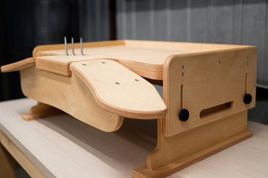 Desktop workbench for watchmaking and jewelry work, featuring adjustable tabletop height, ergonomic armrests and solid plywood build.